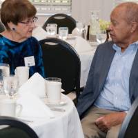 attendees discuss sitting